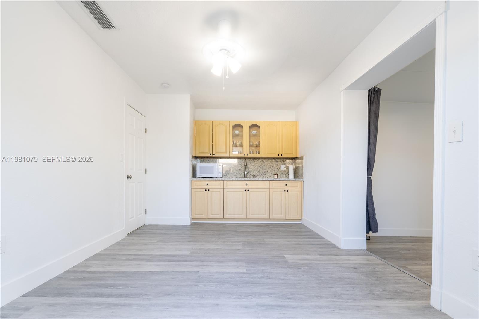 19600 Gulfstream Road Cutler Bay, FL 33157 - Photo 18 of 36 a view of a kitchen with wooden floor and a sink