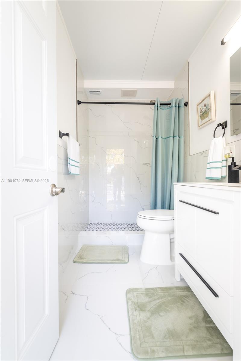 19600 Gulfstream Road Cutler Bay, FL 33157 - Photo 31 of 36 a bathroom with a sink toilet and shower