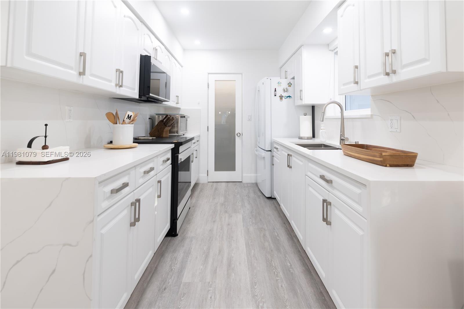 19600 Gulfstream Road Cutler Bay, FL 33157 - Photo 5 of 36 a kitchen with stainless steel appliances a sink stove and cabinets