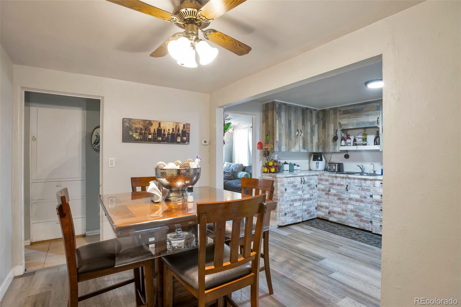 6830 Olive Street Commerce City, CO 80022 - Photo 11 of 25 a view of a dining room with furniture and chandelier