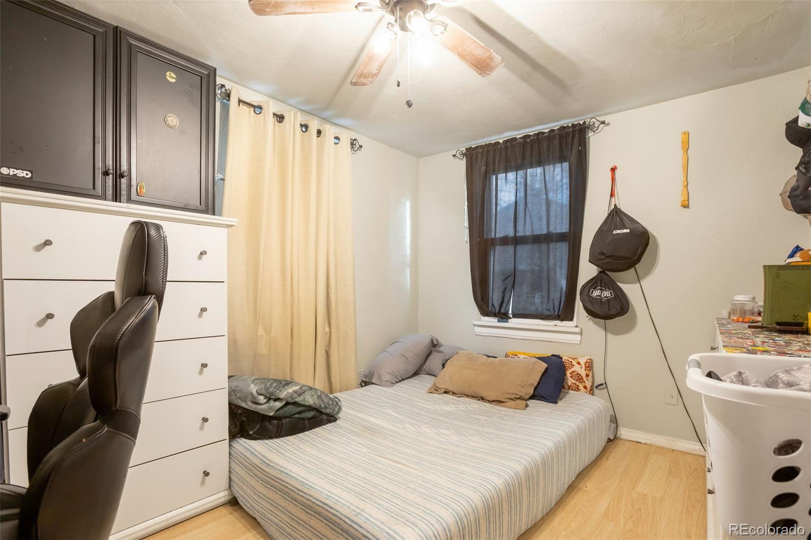 6830 Olive Street Commerce City, CO 80022 - Photo 15 of 25 a bedroom with a bed and a chandelier