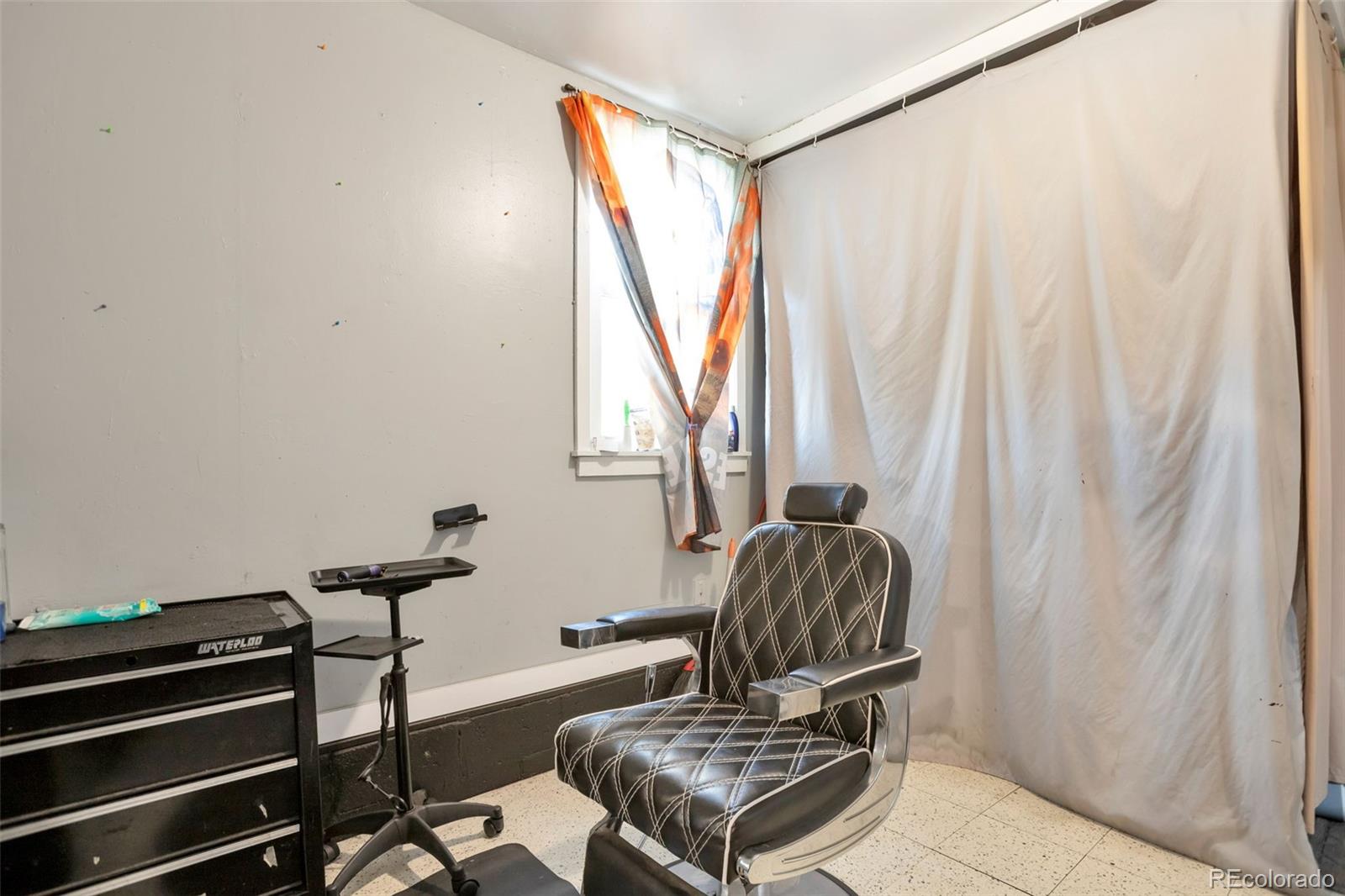 6830 Olive Street Commerce City, CO 80022 - Photo 18 of 25 a living room with a couch and a window