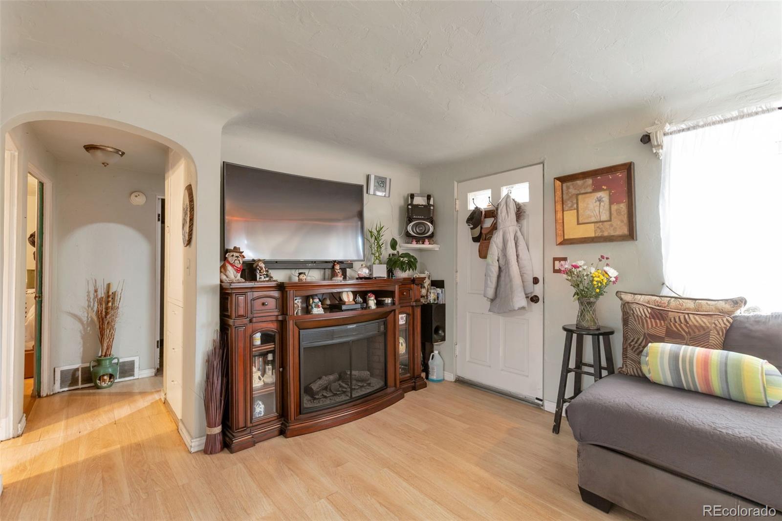 6830 Olive Street Commerce City, CO 80022 - Photo 5 of 25 a living room with furniture and a flat screen tv
