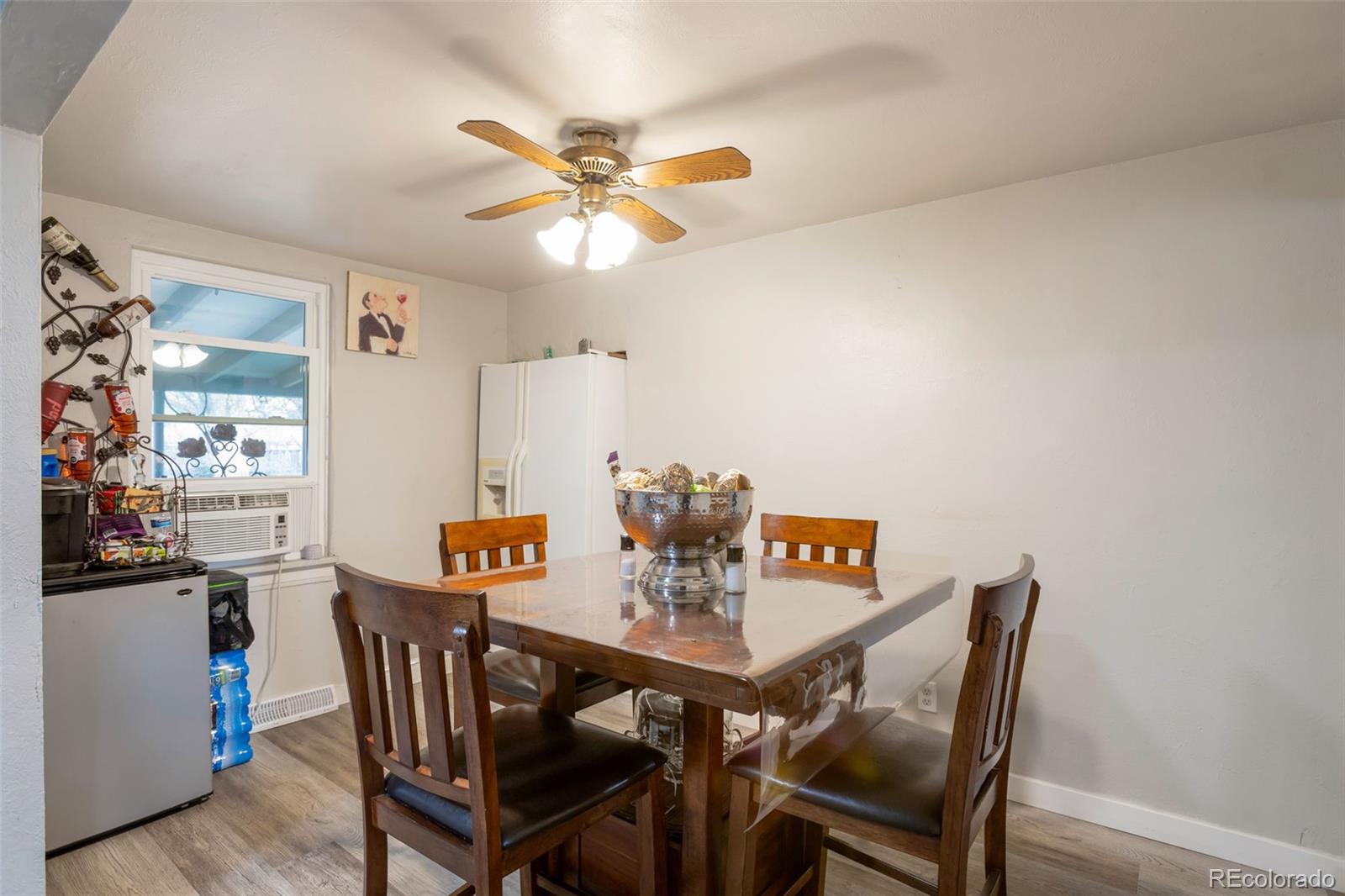 6830 Olive Street Commerce City, CO 80022 - Photo 10 of 25 a view of a dining room with furniture and a chandelier fan