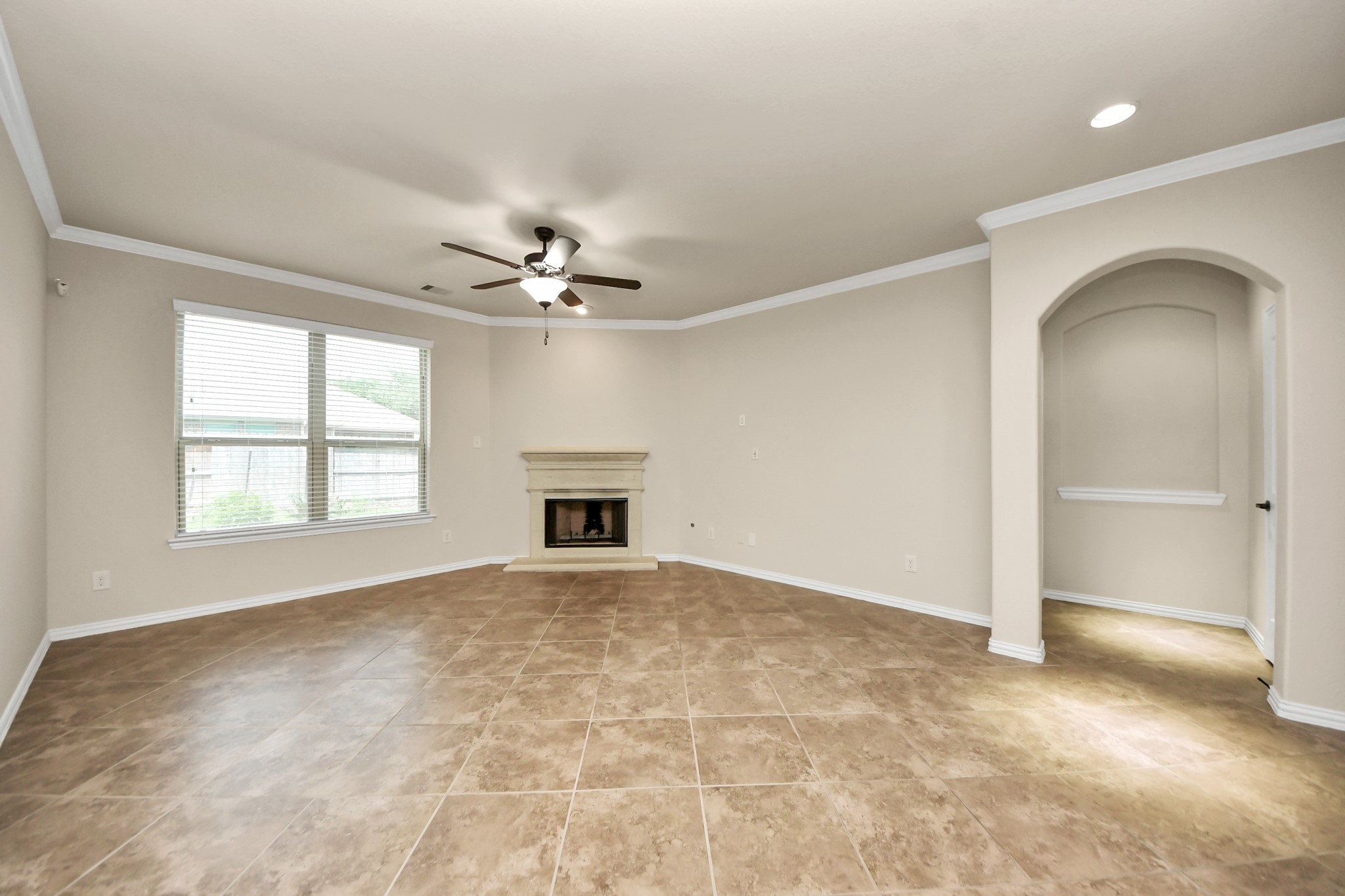 12131 Cove Ridge Lane Cypress, TX 77433 - Photo 13 of 46 an empty room with windows and chandelier fan