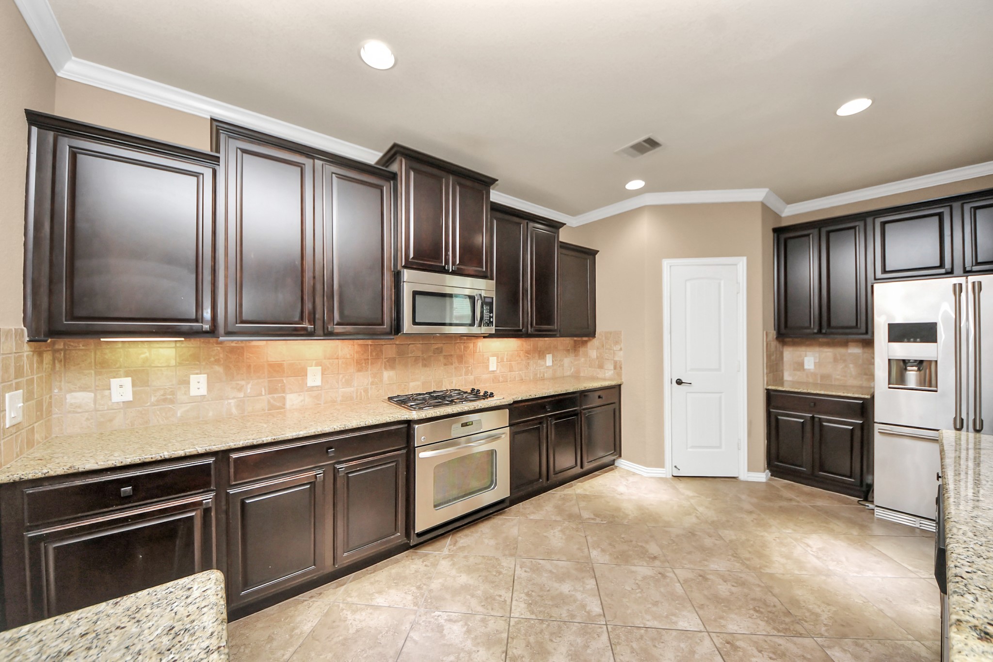 12131 Cove Ridge Lane Cypress, TX 77433 - Photo 25 of 46 a kitchen with stainless steel appliances granite countertop a refrigerator and a sink