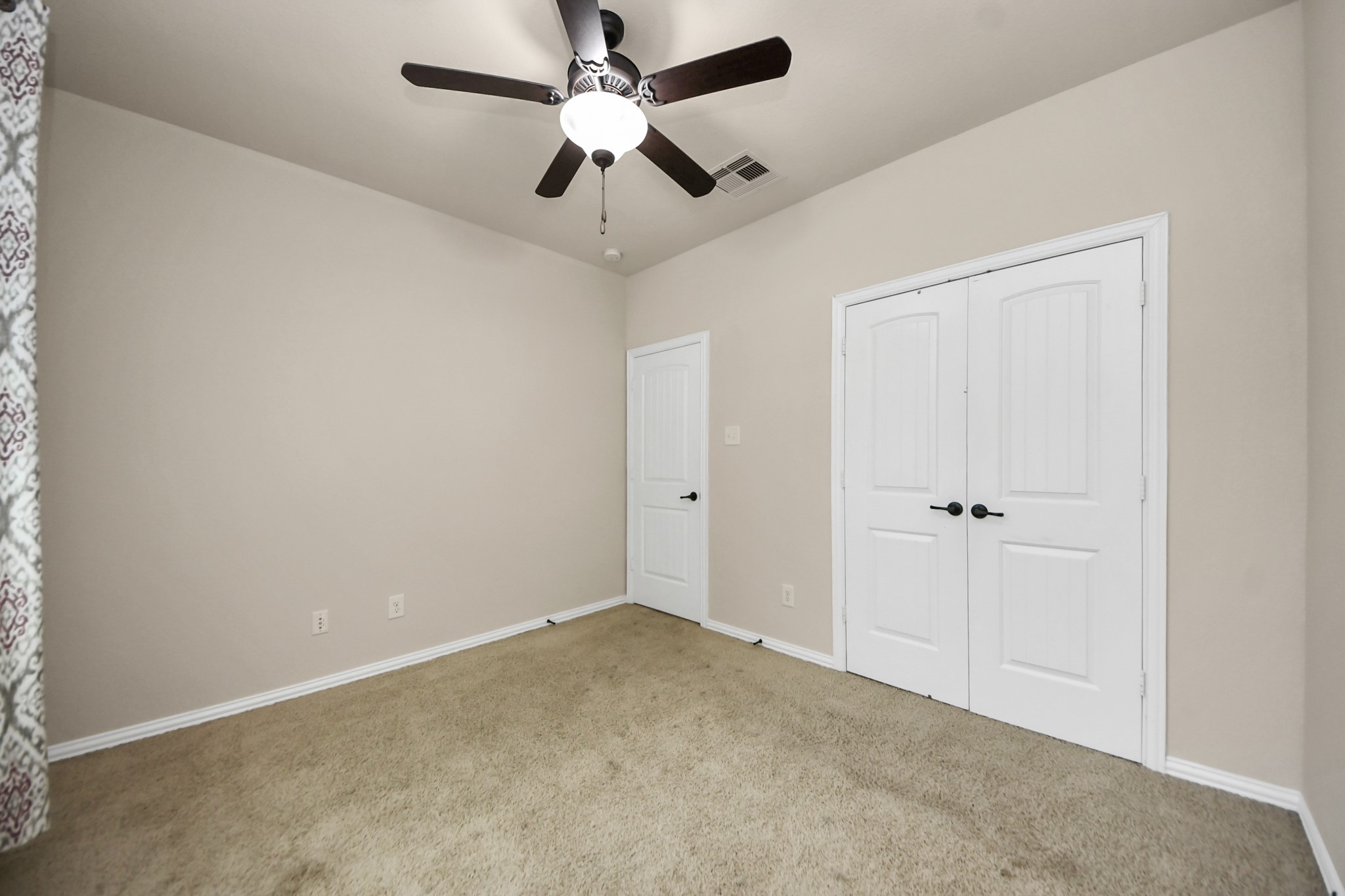 12131 Cove Ridge Lane Cypress, TX 77433 - Photo 7 of 46 an empty room with a ceiling fan and a window