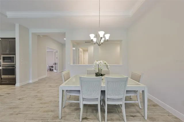 a dining room with furniture and chandelier