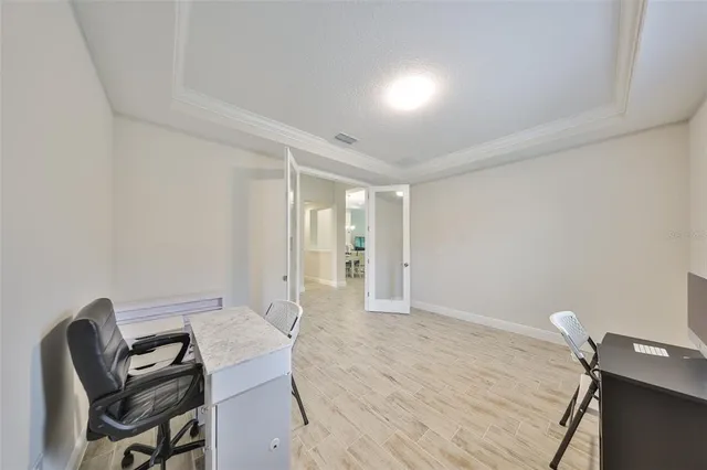 a view of workspace room with wooden floor