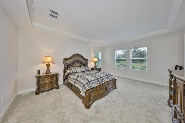 a spacious bedroom with a bed and window