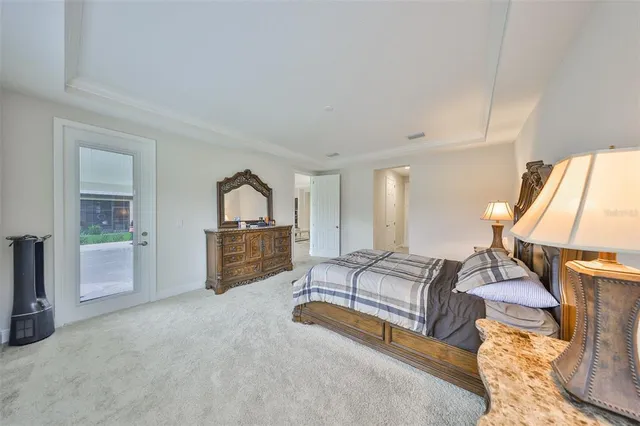 a spacious bedroom with a bed a couch and dresser