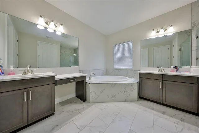 a bathroom with a sink vanity and mirror