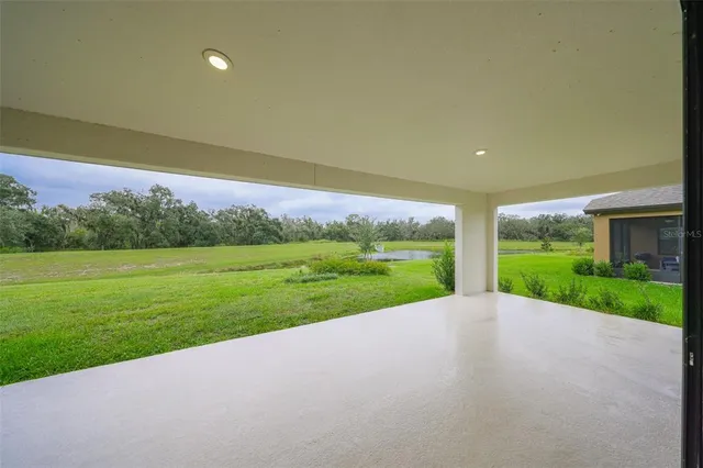 a view of a house with a yard and potted plants