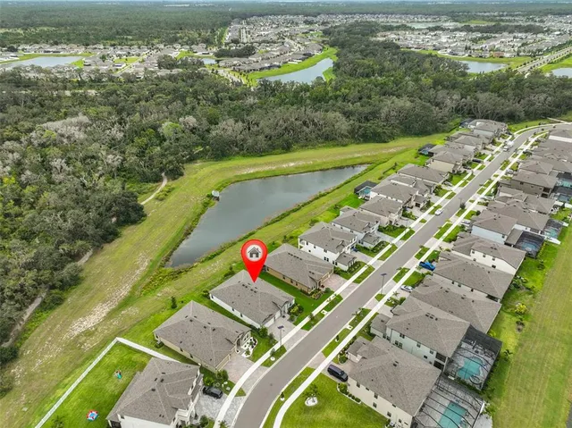 an aerial view of residential houses with outdoor space and swimming pool