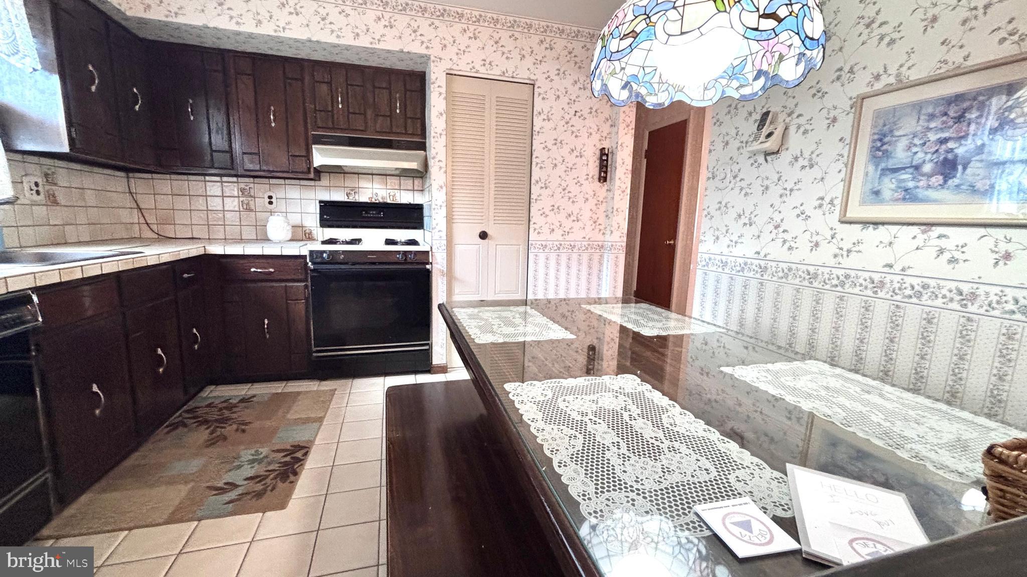 9401 Tulip Street Philadelphia, PA 19114 - Photo 17 of 67 a kitchen with granite countertop a stove and cabinets