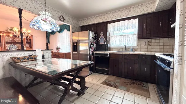 a large kitchen with a table and chairs