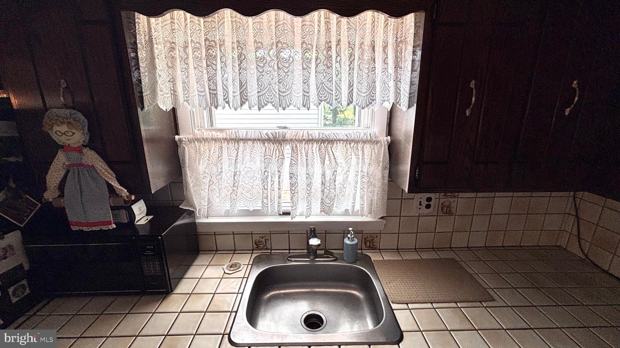 9401 Tulip Street Philadelphia, PA 19114 - Photo 20 of 67 a bathroom with a sink a toilet and window