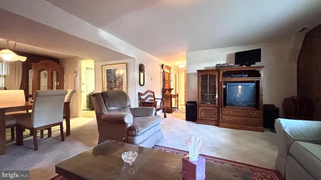 a living room with furniture a lamp and large window