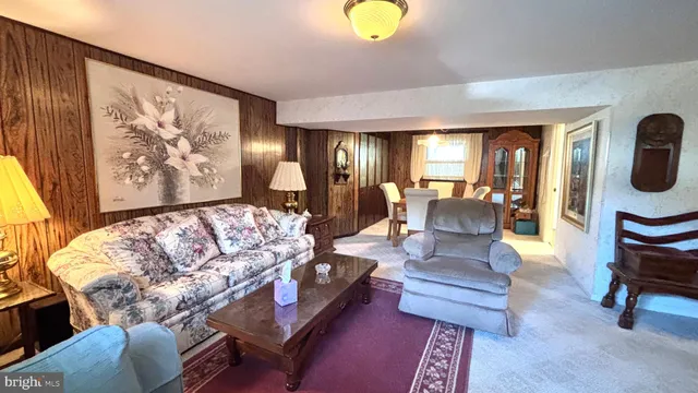 a kitchen with stainless steel appliances granite countertop a refrigerator a sink dishwasher a stove and a dining table with wooden floor