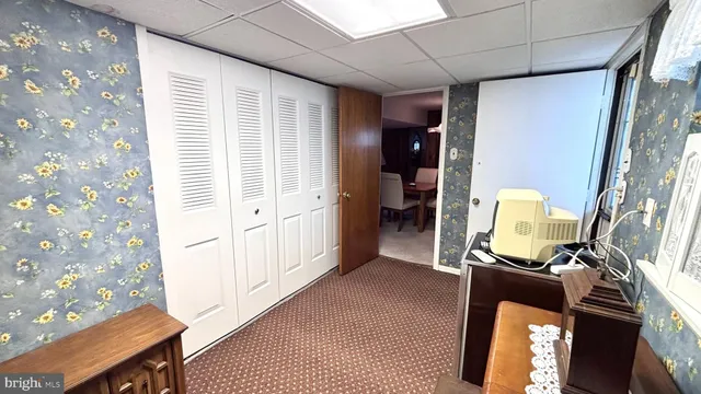 a view of hallway with furniture and a window