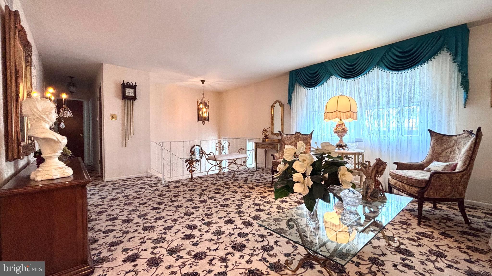 9401 Tulip Street Philadelphia, PA 19114 - Photo 4 of 67 a living room with a couch and a chandelier