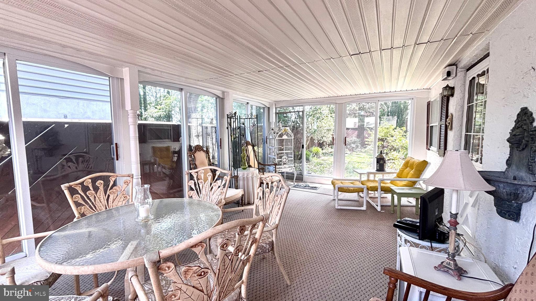 9401 Tulip Street Philadelphia, PA 19114 - Photo 55 of 67 a dining room with furniture large windows and a chandelier