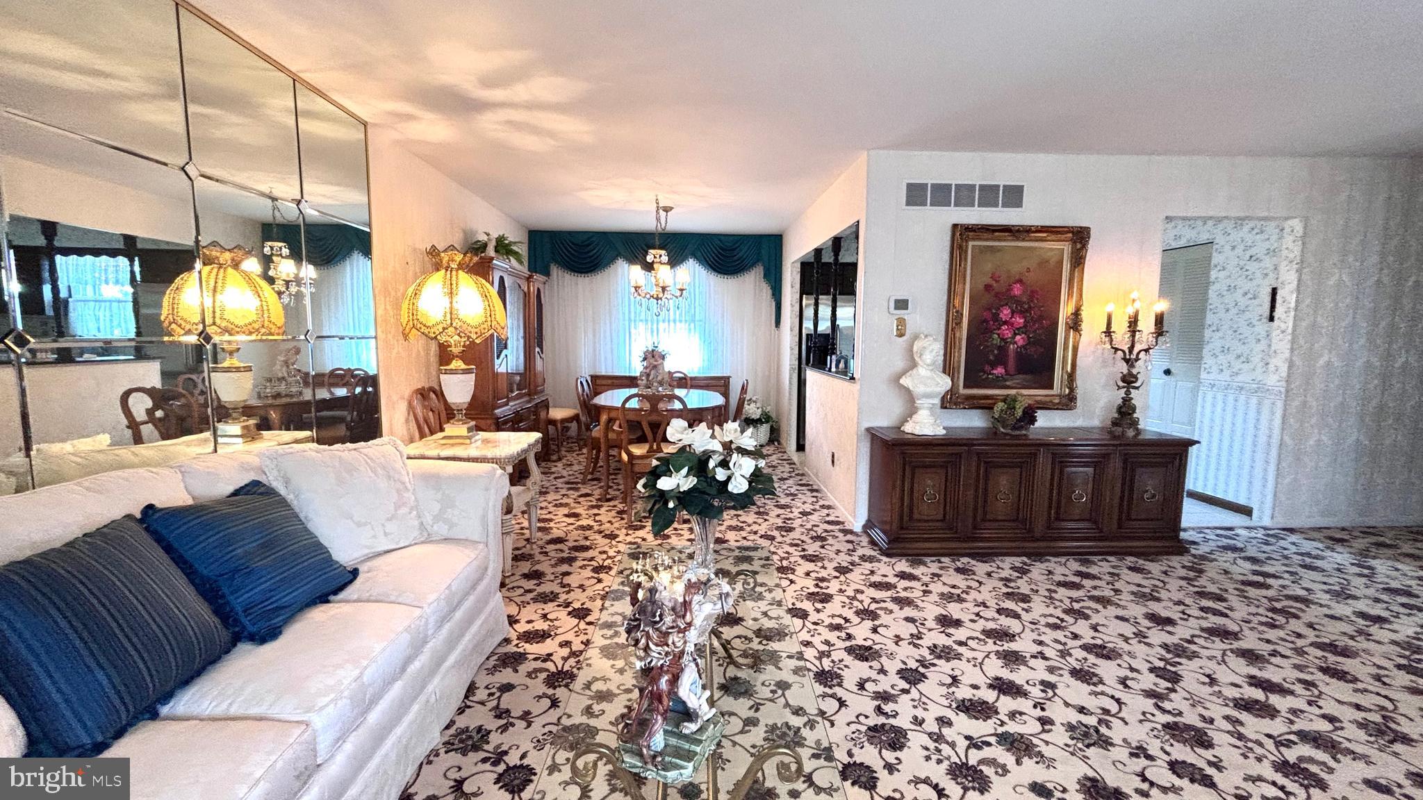 9401 Tulip Street Philadelphia, PA 19114 - Photo 6 of 67 a living room with furniture a large window and a chandelier