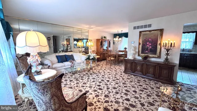 a living room with furniture a large window and a table