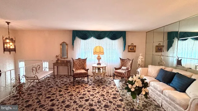 a living room with furniture a rug and a painting on the wall