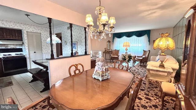 a view of a dining room with furniture a chandelier and wooden floor