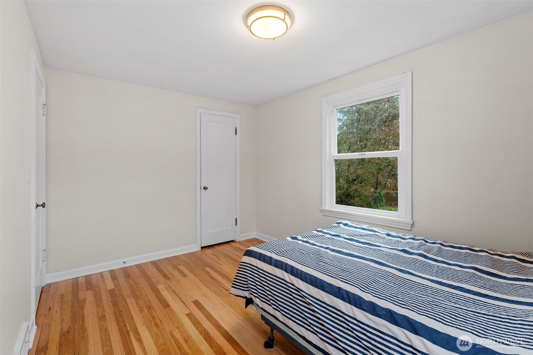 9748 Dayton Avenue North Seattle, WA 98103 - Photo 16 of 39 a view of a room with wooden floor and window