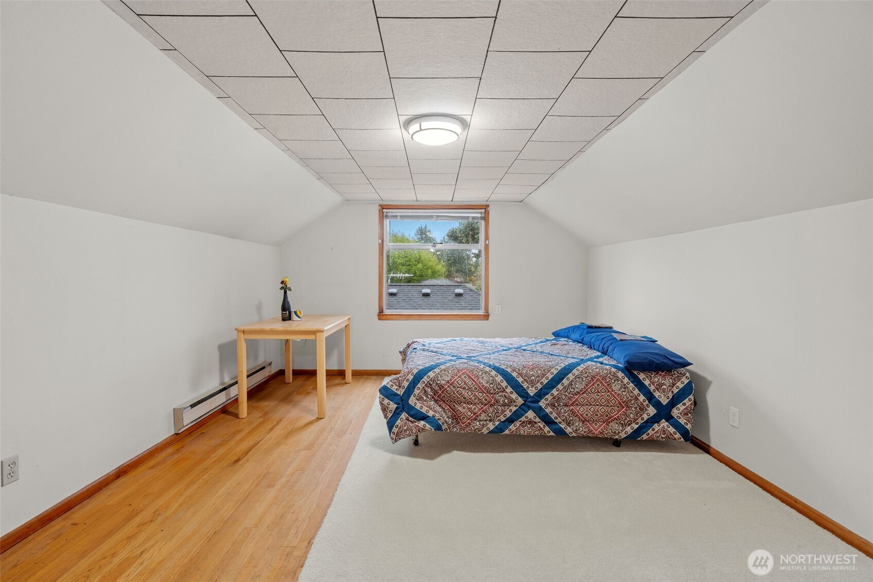 9748 Dayton Avenue North Seattle, WA 98103 - Photo 21 of 39 a bedroom with a bed and a window