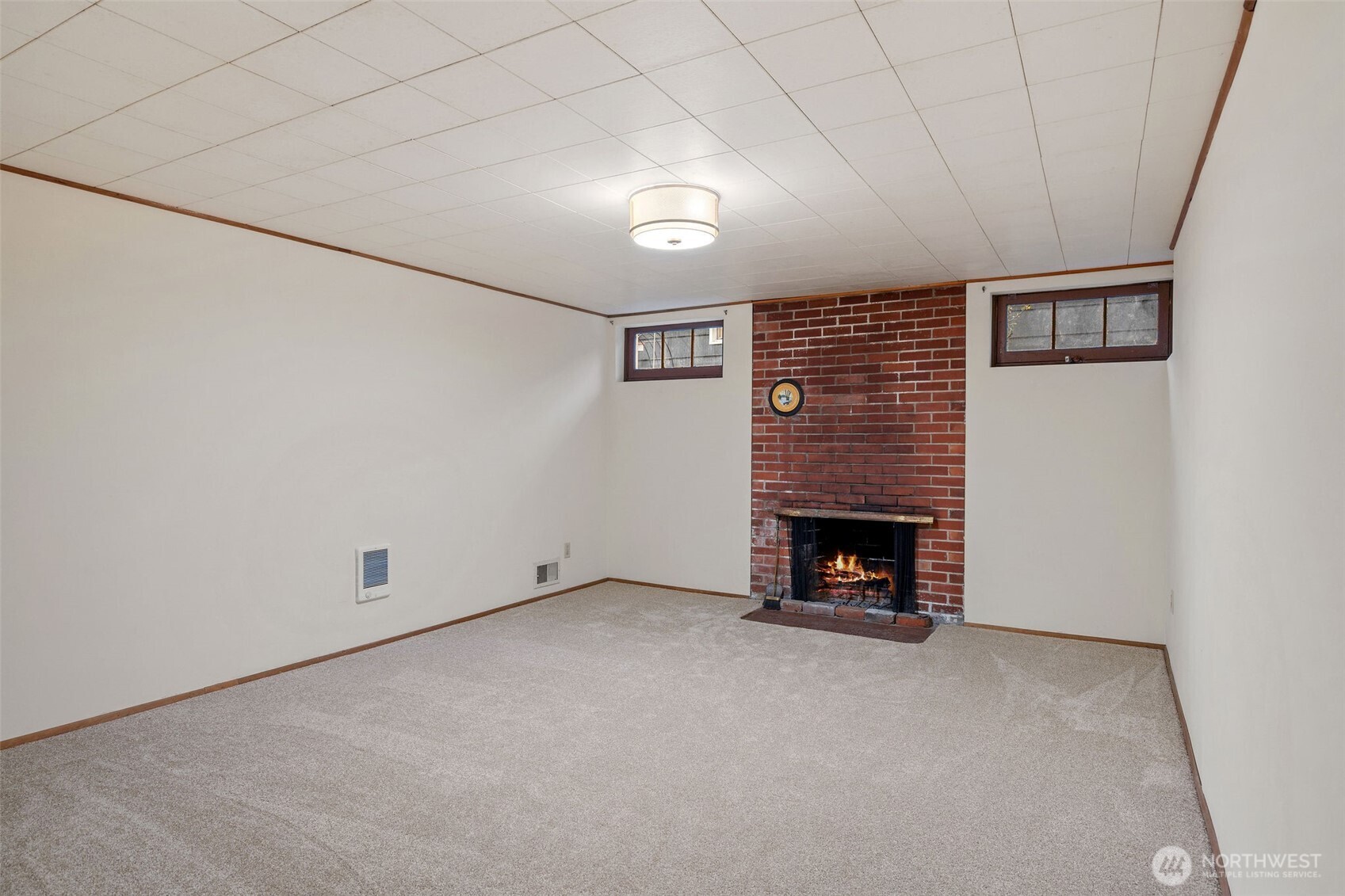 9748 Dayton Avenue North Seattle, WA 98103 - Photo 25 of 39 a view of an empty room with a fireplace