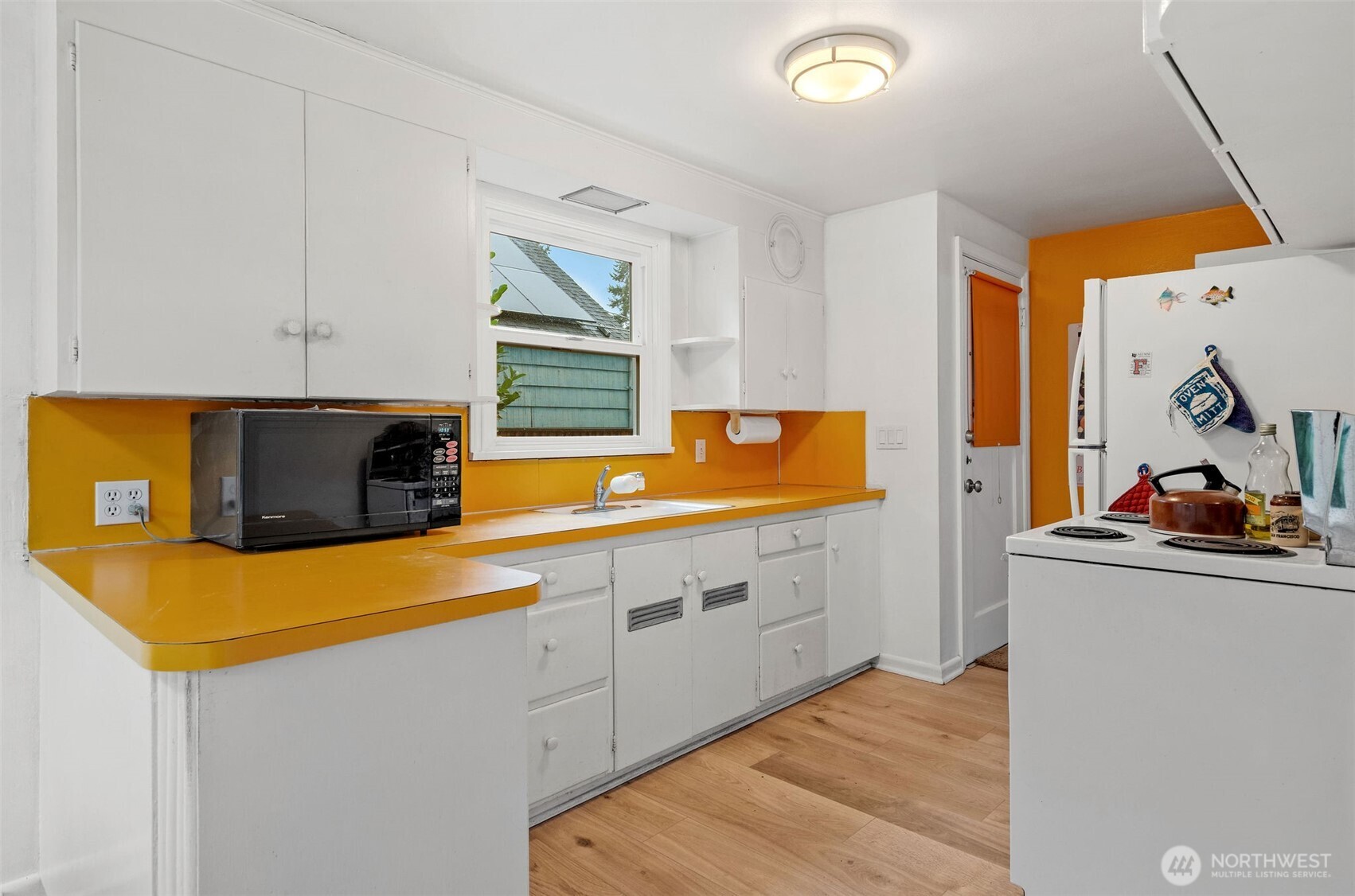 9748 Dayton Avenue North Seattle, WA 98103 - Photo 8 of 39 a kitchen with stainless steel appliances a stove a sink and a refrigerator