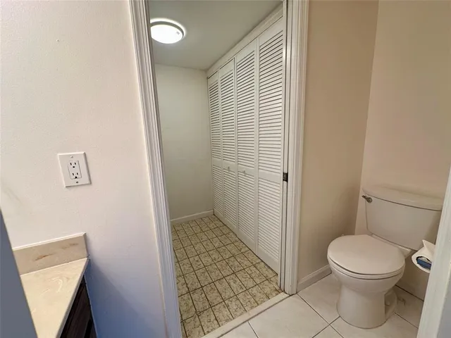 a bathroom with a sink a toilet a mirror and shower