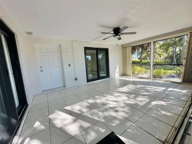 a view of house with yard and tree in front of it