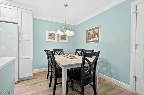 a view of a dining room with furniture wooden floor and a chandelier
