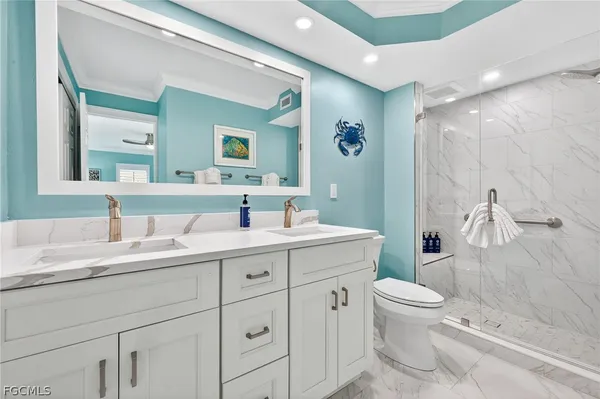 a bathroom with a granite countertop sink mirror and toilet