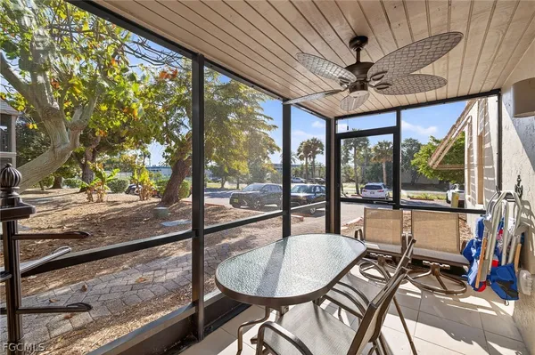 a dining room with furniture and a floor to ceiling window