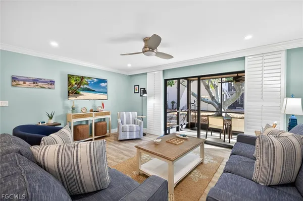 a bedroom with furniture and large windows