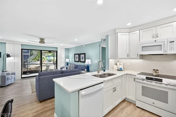 a kitchen with a sink stove and cabinets