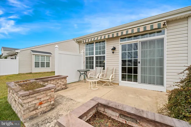 a front view of a house with outdoor seating