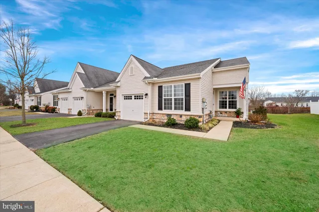 a view of a house with a yard patio and tree