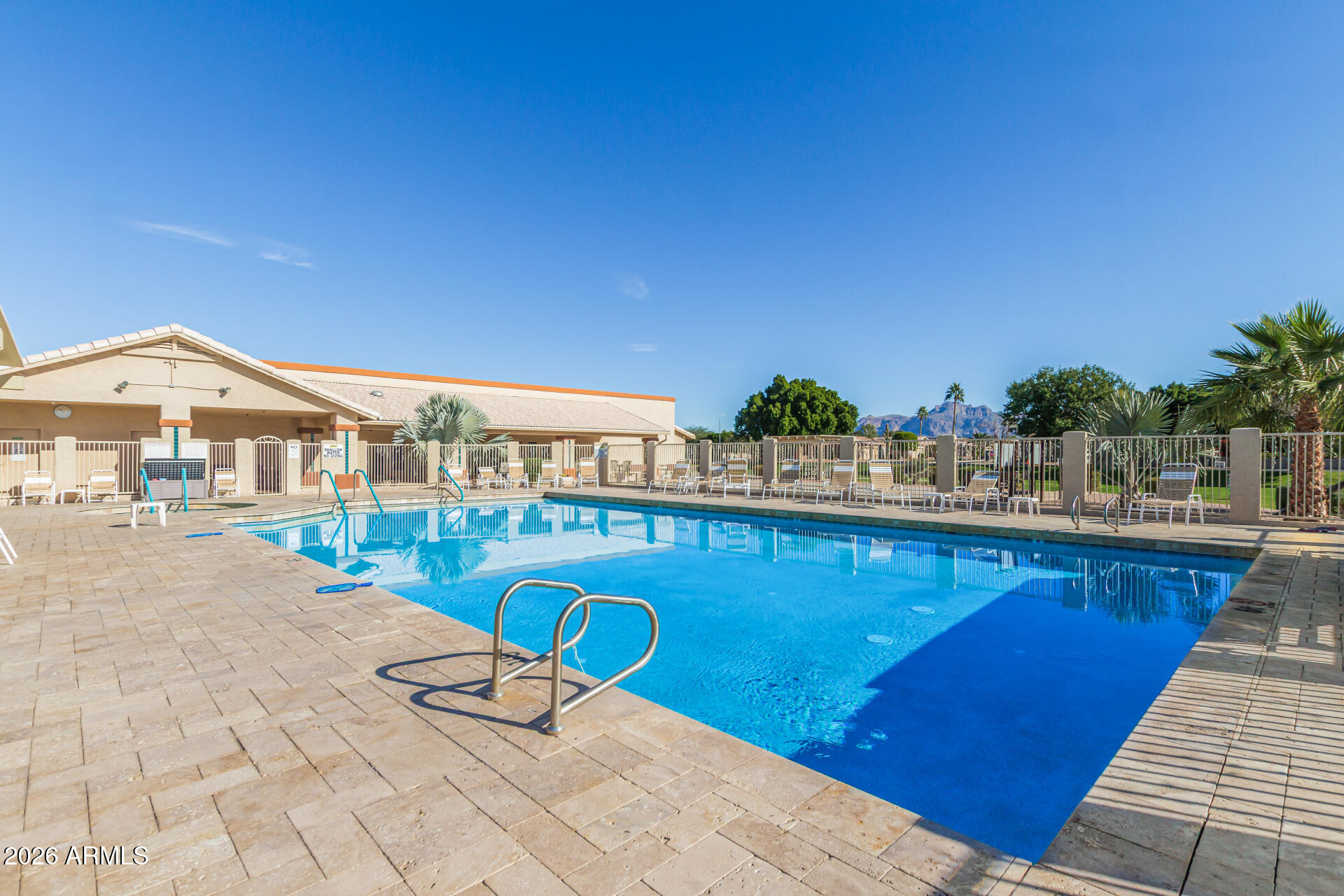 2101 South Meridian Road, Unit 45 Apache Junction, AZ 85120 - Photo 33 of 36 a view of a swimming pool with lounge chairs