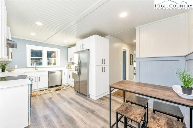 a kitchen with a table and chairs in it