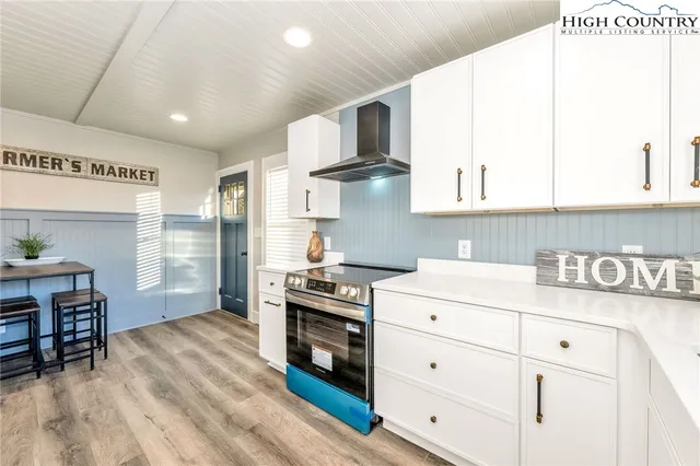 a kitchen with granite countertop a stove a sink and a refrigerator