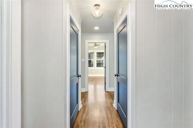 a view of hallway with wooden floor