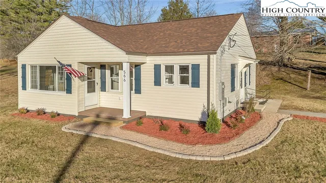 a view of house with yard outdoor seating area