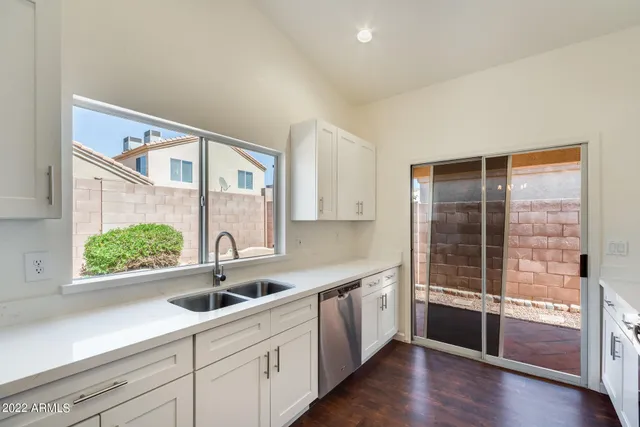 a kitchen with a sink and large window
