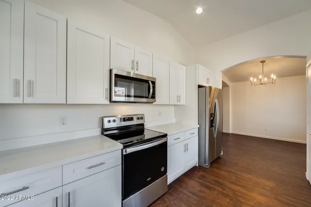a kitchen with stainless steel appliances a refrigerator sink and microwave